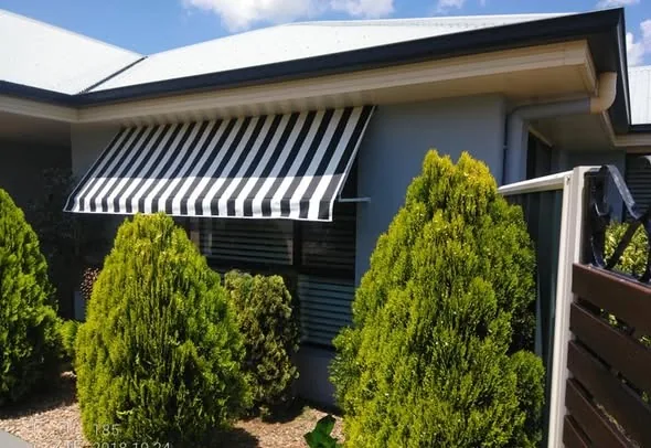 Black and white striped folding-arm awning