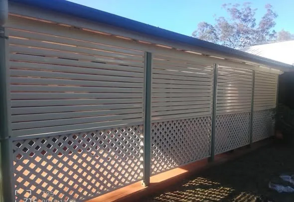 Aluminium louvre privacy screen with lattice along a verandah