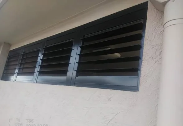 External charcoal shutters on a rendered wall